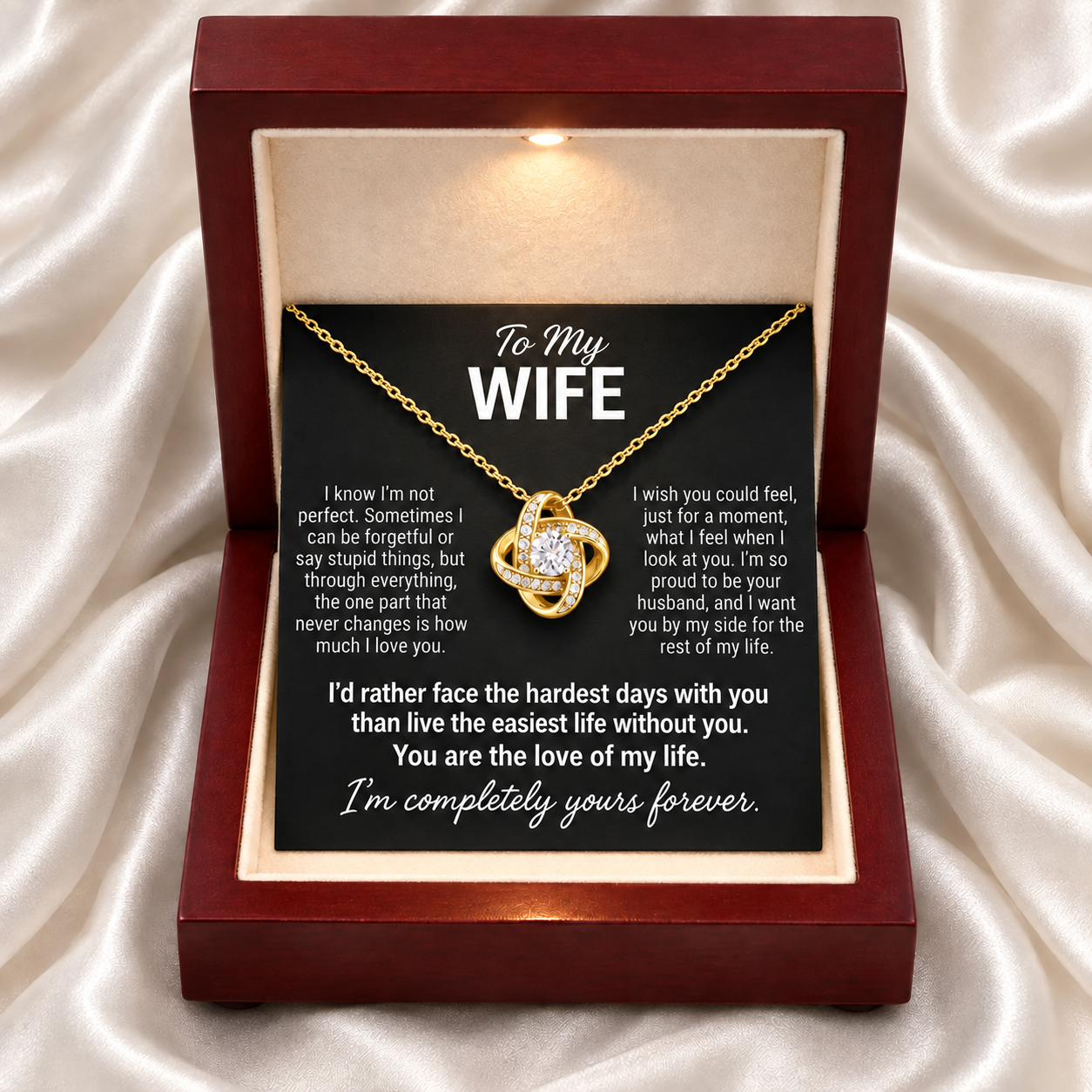 The To My Wife message card and gold love knot necklace in a lit gift box
