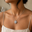 Silver Forever Yours Love Knot necklace worn with ivory linen in a softly lit profile portrait